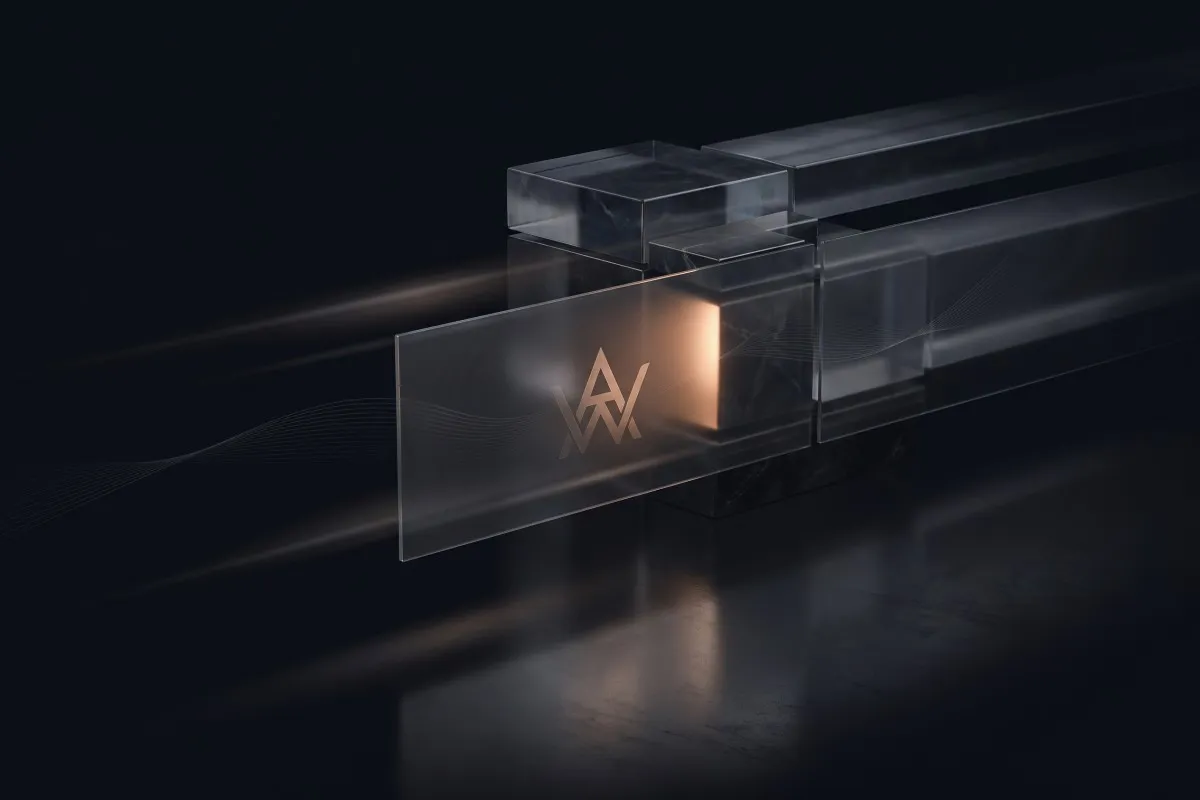 A frosted glass panel etched with an angular monogram sits against glass blocks glowing amber in the dark.
